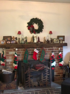 Our mantel, 2018, DH's original stocking from 1956 on left.