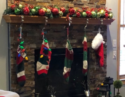 DSD's mantel, 2018, her and DSIL's stockings on left, the two I knit for DGC1 and DGC2 in middle. DGC3 is waiting me to knit his (so he has a temporary substitute).
